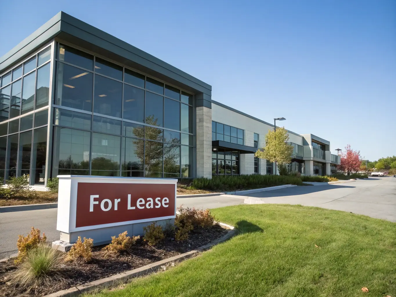 A modern commercial building with a 'For Lease' sign, emphasizing the availability of prime commercial spaces.